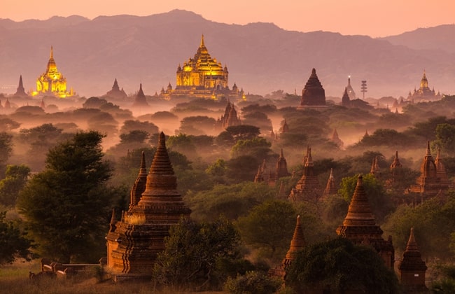 Pagoda landscape under a warm sunset in the plain of Bagan, Myanmar